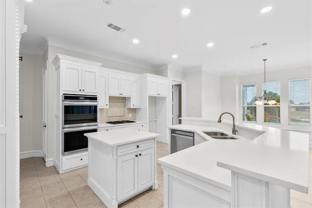 a kitchen that has a sink and a stove top oven