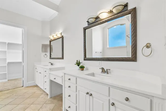 a bathroom with double vanity sink two mirror and a mirror