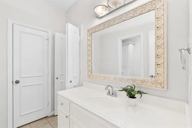 a bathroom with a sink a vanity and a mirror