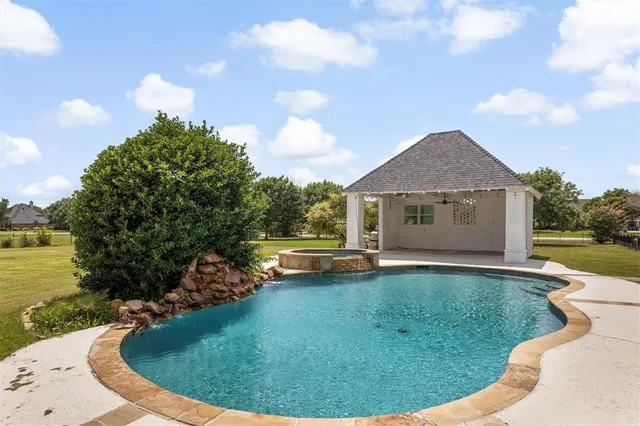 a view of a house with swimming pool and sitting area
