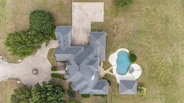 an aerial view of a house with outdoor space