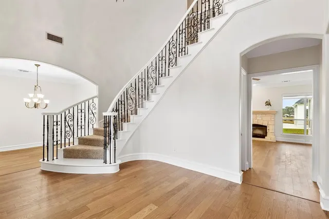 a view of entryway and hall with wooden floor