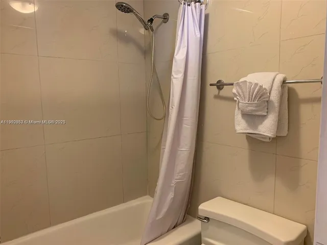 a bathroom with a shower and toilet