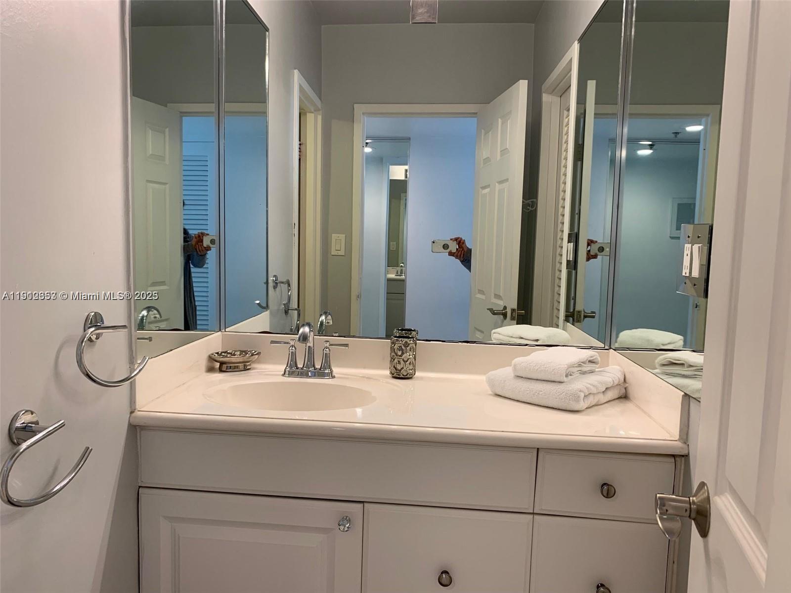 100 Lincoln Road, Unit 638 Miami Beach, FL 33139 - Photo 15 of 26 a bathroom with a sink and a mirror