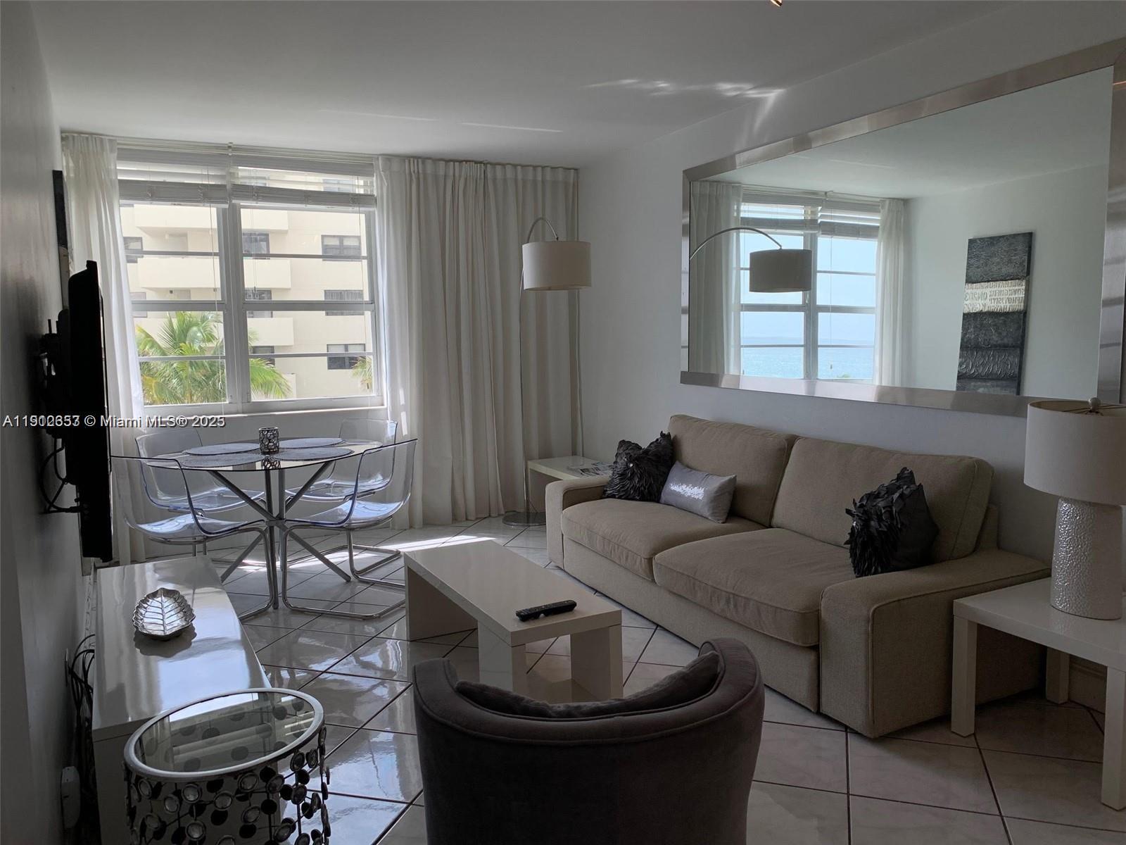 100 Lincoln Road, Unit 638 Miami Beach, FL 33139 - Photo 2 of 26 a living room with furniture and a large window