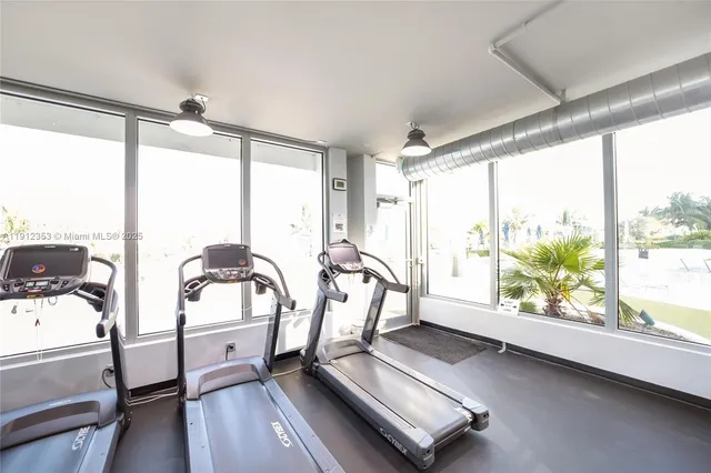 a view of a room with wooden floor and windows