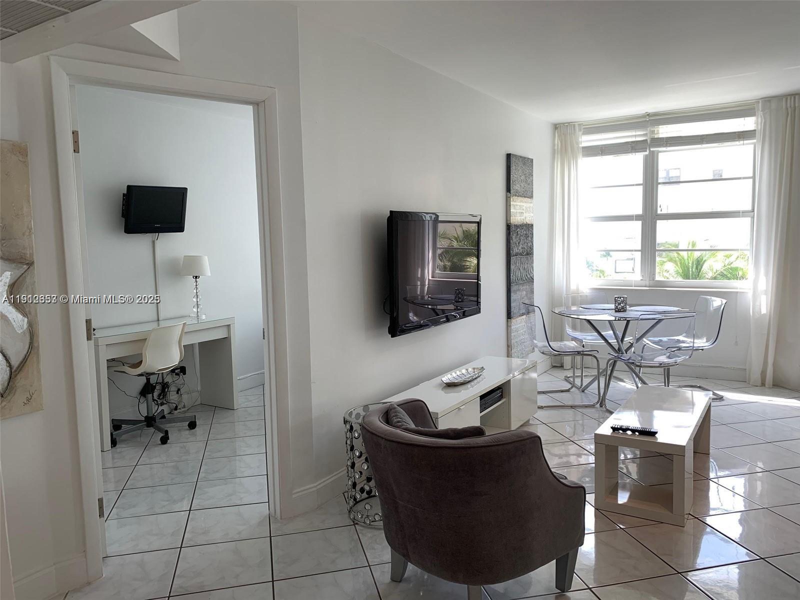 100 Lincoln Road, Unit 638 Miami Beach, FL 33139 - Photo 3 of 26 a living room with furniture and a flat screen tv
