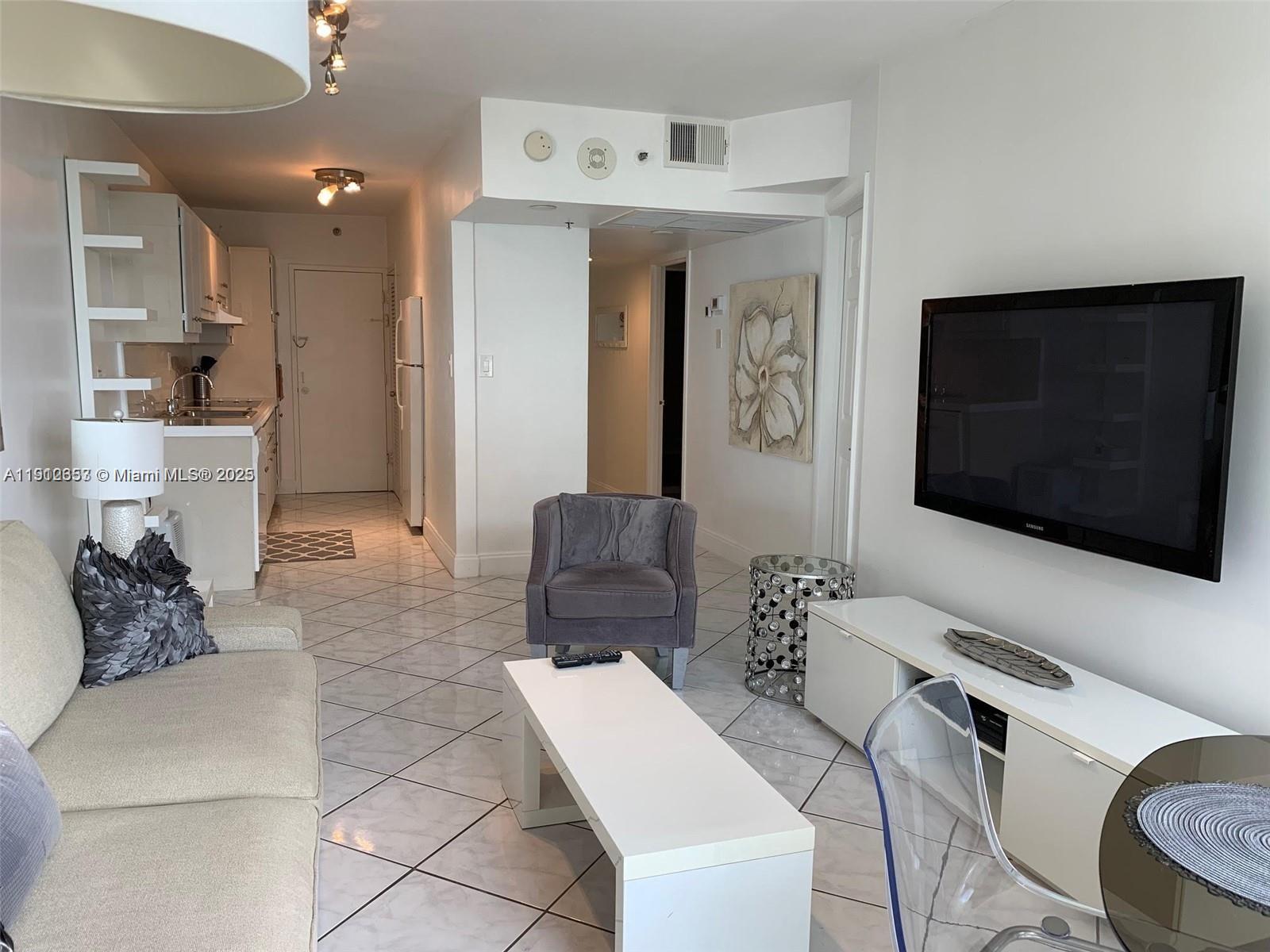 100 Lincoln Road, Unit 638 Miami Beach, FL 33139 - Photo 6 of 26 a living room with furniture and a flat screen tv