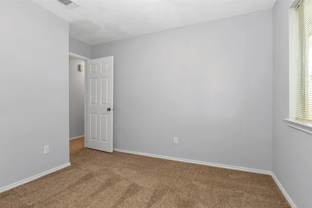 a view of a house with backyard and a tree