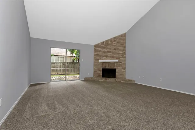 an empty room with mirror and windows