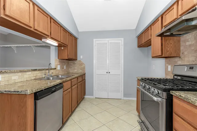 a stove top oven sitting inside of a kitchen