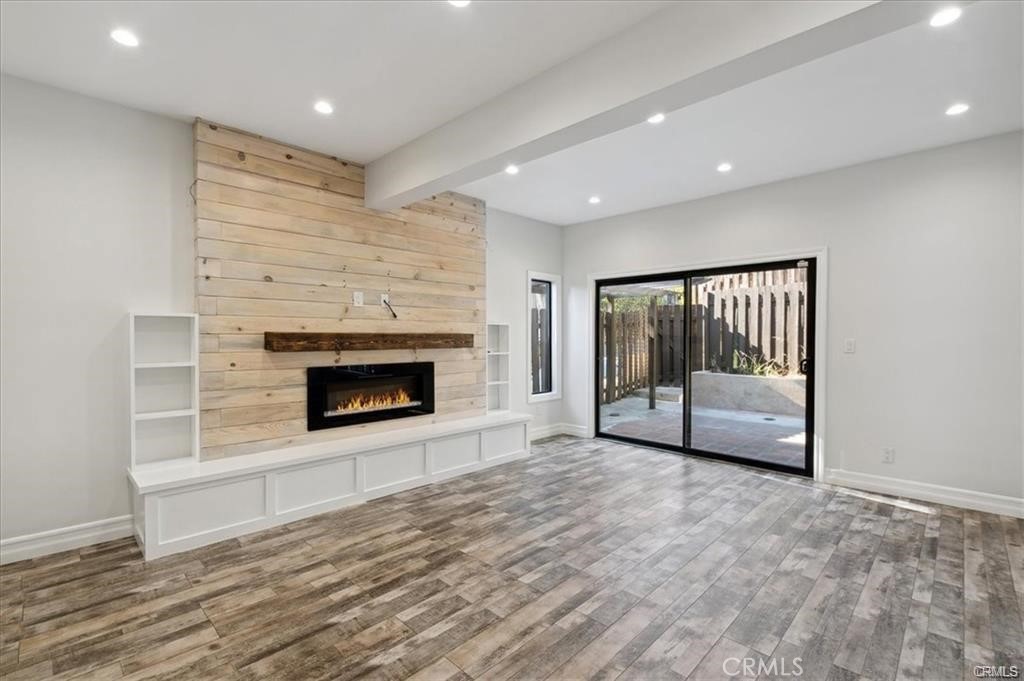10831 Roycroft Street, Unit 72 Sun Valley, CA 91352 - Photo 12 of 33 a view of an empty room with a fireplace and a window