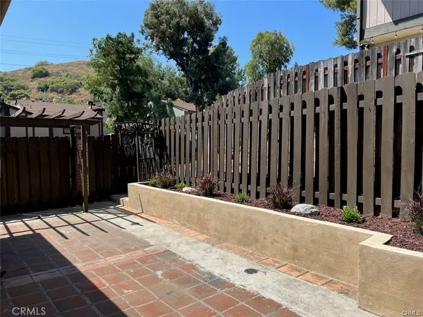 a view of a wooden fence with a pathway