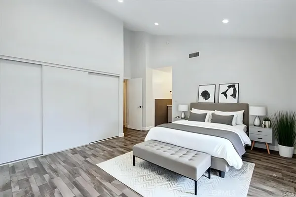 a spacious bedroom with a bed and a table