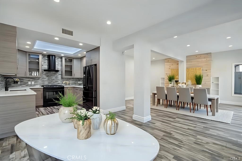 10831 Roycroft Street, Unit 72 Sun Valley, CA 91352 - Photo 2 of 33 a dining room with stainless steel appliances kitchen island granite countertop a dining table chairs and a living room view