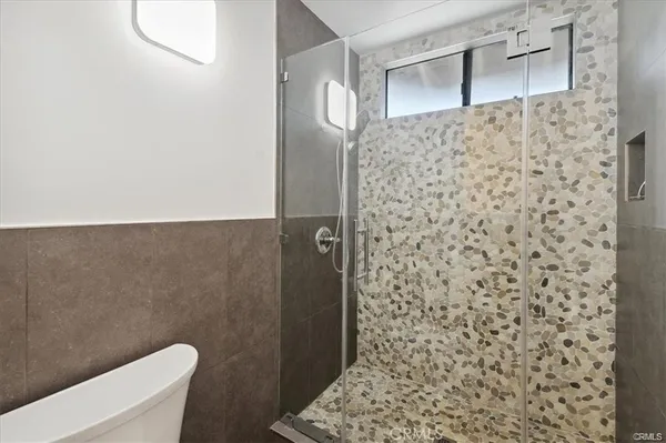 a bathroom with a toilet and a shower