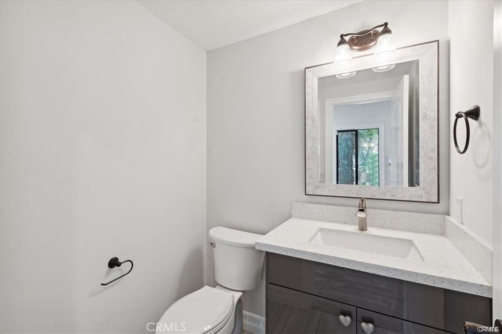 10831 Roycroft Street, Unit 72 Sun Valley, CA 91352 - Photo 7 of 33 a bathroom with a sink vanity mirror and toilet