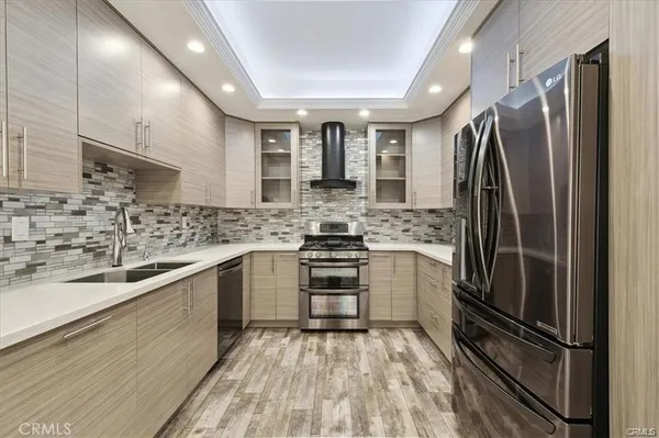 a kitchen with stainless steel appliances a refrigerator sink and microwave
