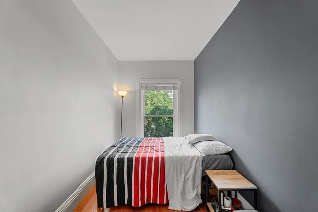 a bed sitting in a bedroom next to a window