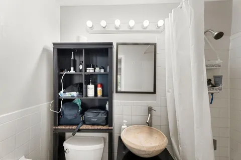 a bathroom with a toilet a sink and mirror