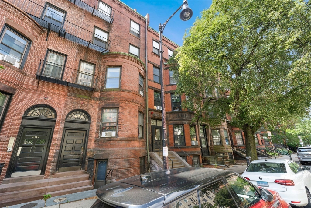 511 Beacon Street, Unit 11 Boston, MA 02215 - Photo 18 of 19 a front view of a residential apartment building with a yard