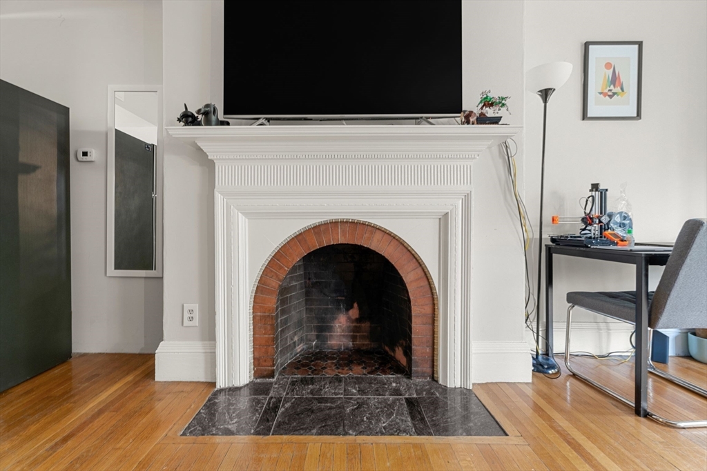 511 Beacon Street, Unit 11 Boston, MA 02215 - Photo 6 of 19 a view of a livingroom with fireplace and workspace