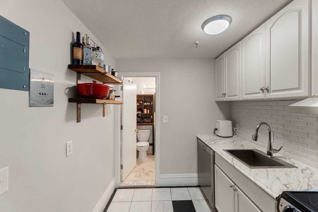 511 Beacon Street, Unit 11 Boston, MA 02215 - Photo 9 of 19 a kitchen with stainless steel appliances granite countertop a sink and a refrigerator