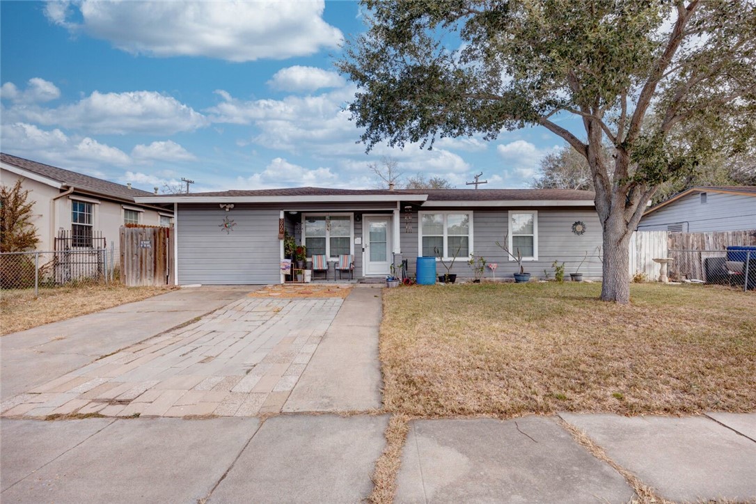 3906 Barnes Street Corpus Christi, TX 78415 - Photo 1 of 12 a view of a house with large tree and wooden fence