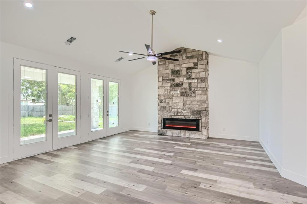 2940 Henry Road Lancaster, TX 75134 - Photo 4 of 10 a view of an empty room with a window and a fireplace