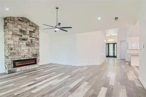 a view of an empty room with a fireplace