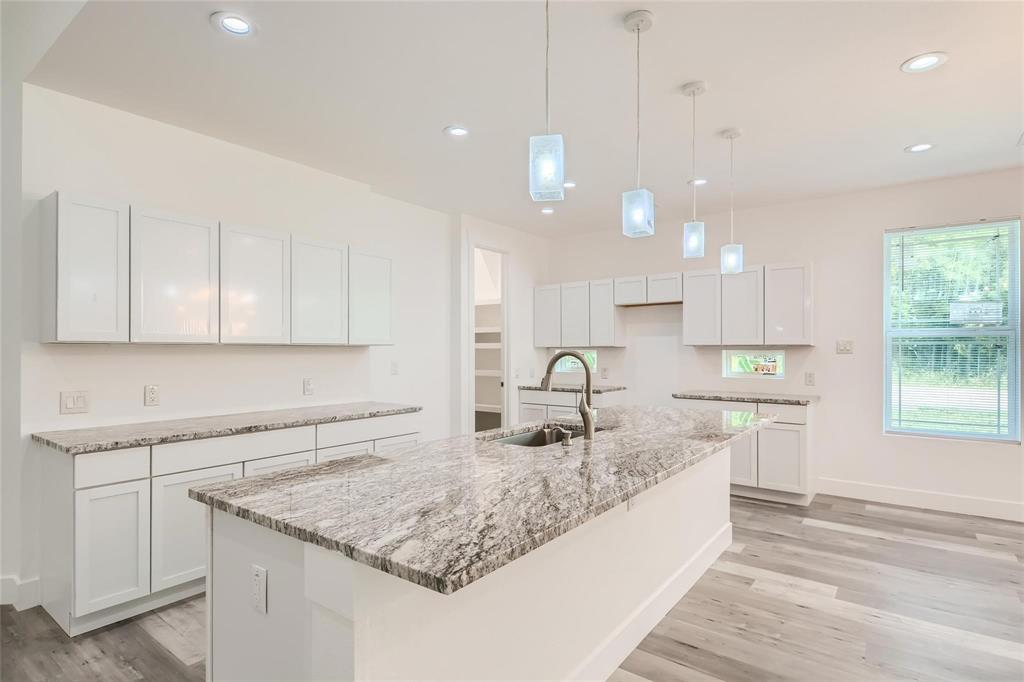 2940 Henry Road Lancaster, TX 75134 - Photo 7 of 10 a large kitchen with kitchen island a sink stainless steel appliances and cabinets