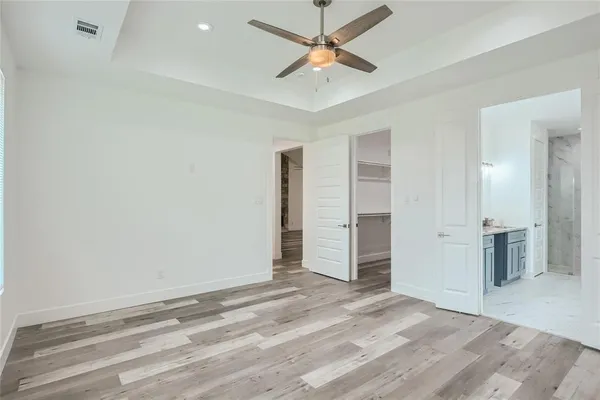 an empty space with closet and a ceiling fan