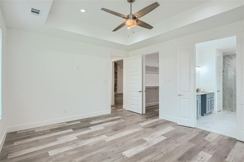 2940 Henry Road Lancaster, TX 75134 - Photo 8 of 10 an empty space with closet and a ceiling fan