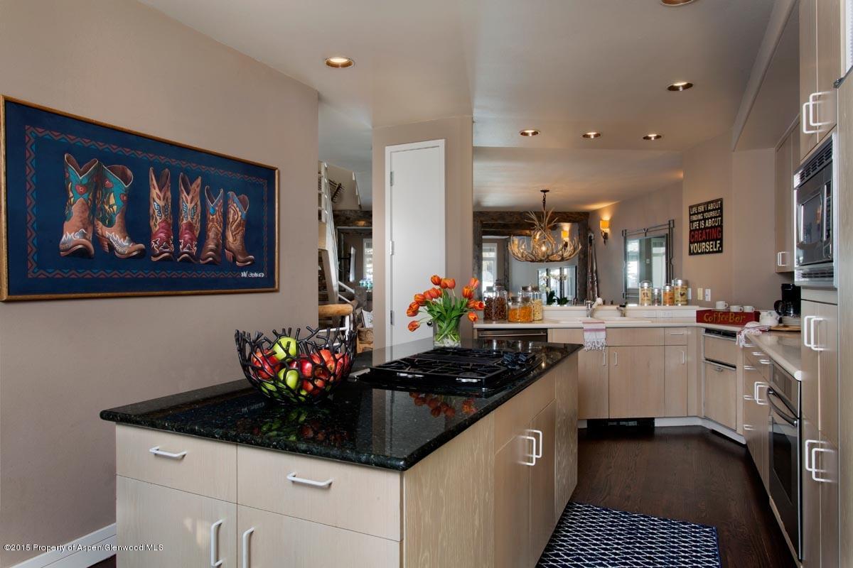 381 Ridge Road, Unit B3 Snowmass Village, CO 81615 - Photo 5 of 18 a kitchen with stainless steel appliances granite countertop a stove a sink and a refrigerator