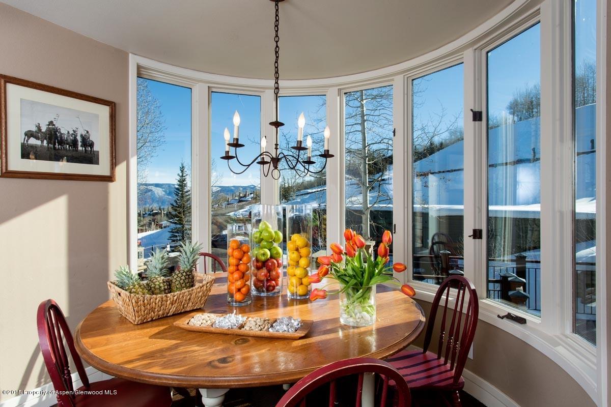 381 Ridge Road, Unit B3 Snowmass Village, CO 81615 - Photo 6 of 18 a view of a dining room with furniture window and wooden floor