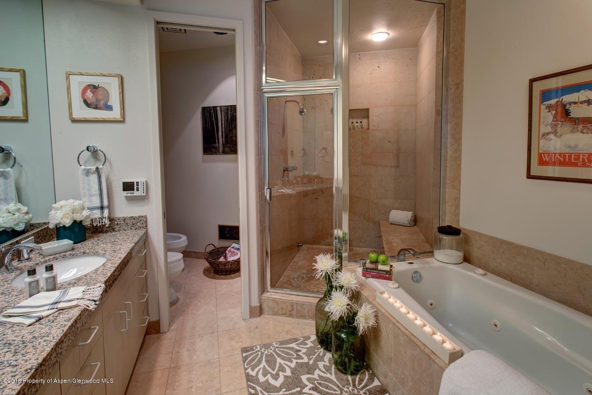 381 Ridge Road, Unit B3 Snowmass Village, CO 81615 - Photo 9 of 18 a bathroom with a granite countertop tub sink and mirror