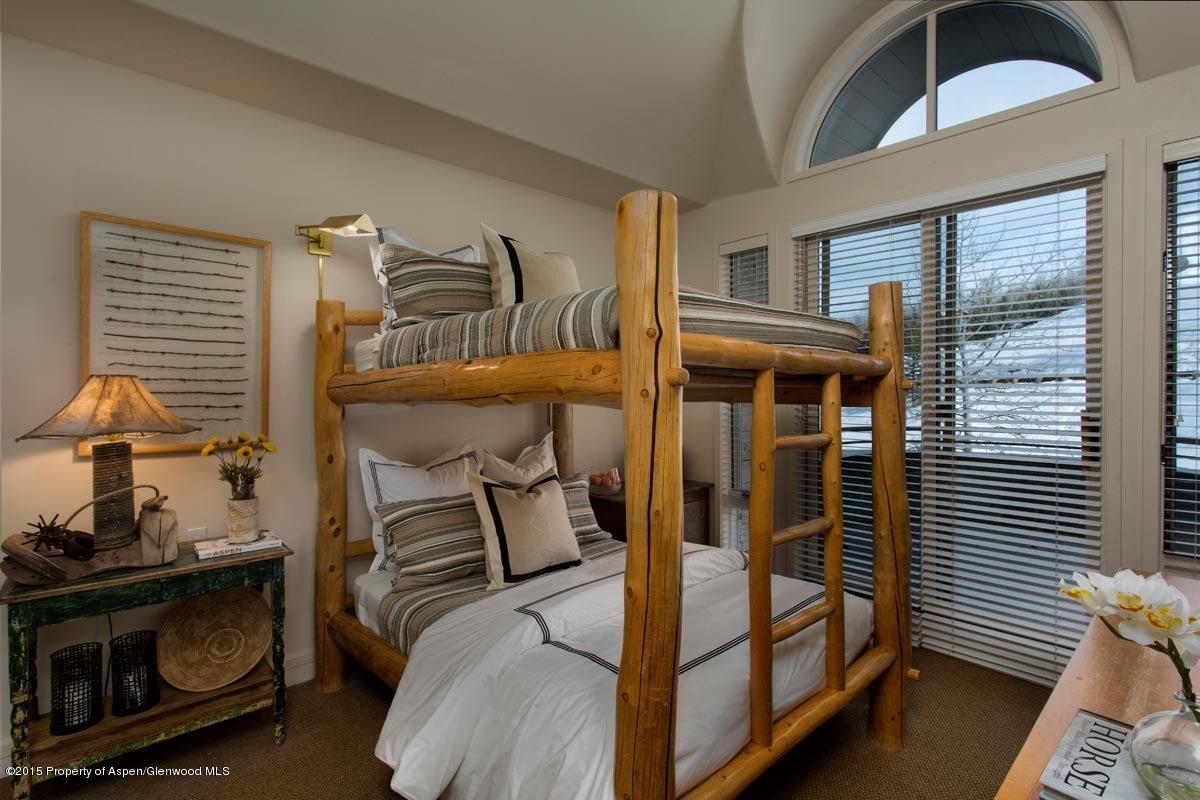 381 Ridge Road, Unit B3 Snowmass Village, CO 81615 - Photo 10 of 18 a bedroom with a bed and a window