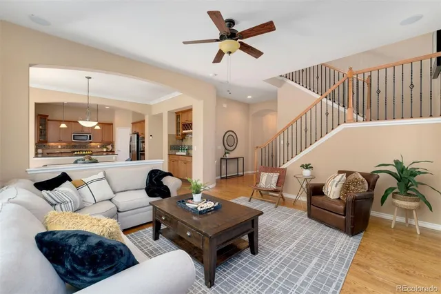 a living room with furniture ceiling fan and a rug