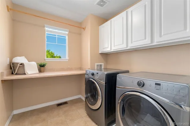a utility room with sink dryer and washer