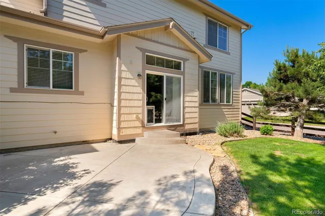 a view of a house with backyard and sitting area