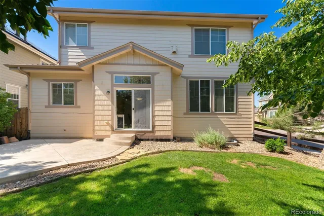 a view of a house with a yard and sitting area