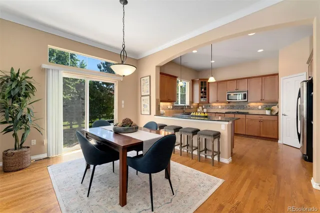 a view of a dining room with furniture window and wooden floor