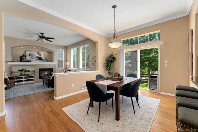 a dining room with furniture a chandelier and wooden floor