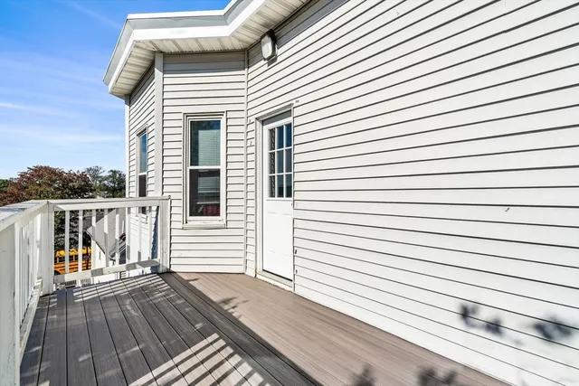 a view of balcony with wooden floor and fence