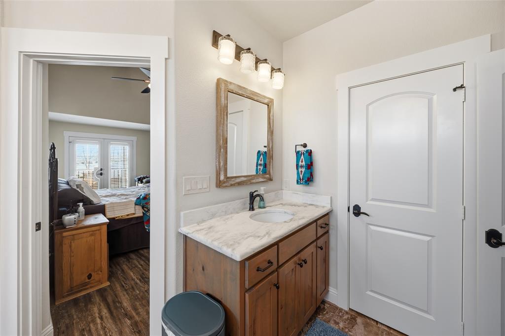 3105 Pastor Street Dallas, TX 75212 - Photo 19 of 28 Bathroom with vanity, ceiling fan, ensuite bathroom, and dark wood-style flooring