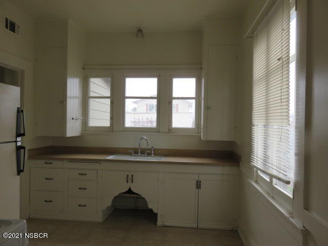 313 West Walnut Avenue Lompoc, CA 93436 - Photo 4 of 12 a bathroom with a granite countertop sink and a window
