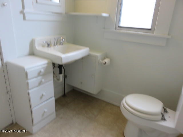 313 West Walnut Avenue Lompoc, CA 93436 - Photo 7 of 12 a bathroom with a sink a toilet and a window