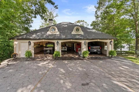 a dining room with stainless steel appliances kitchen island granite countertop a dining table chairs and view living room