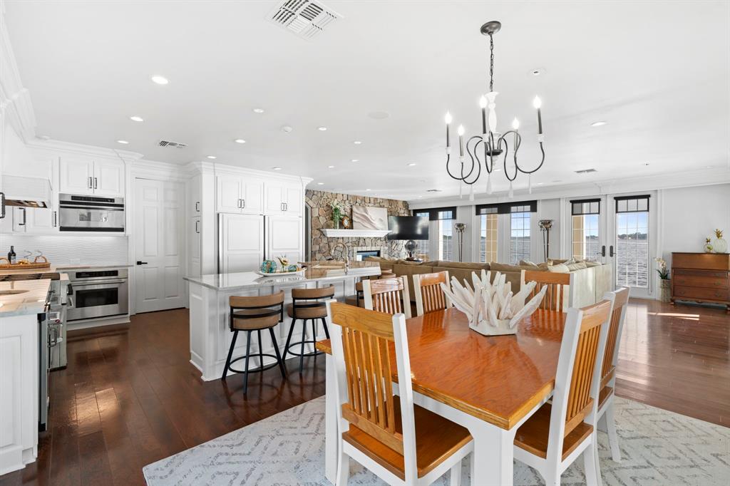 15996 Eastside Road Tyler, TX 75707 - Photo 18 of 40 a view of a dining room and livingroom with furniture wooden floor a chandelier