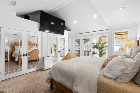 a bedroom with bed and a potted plant